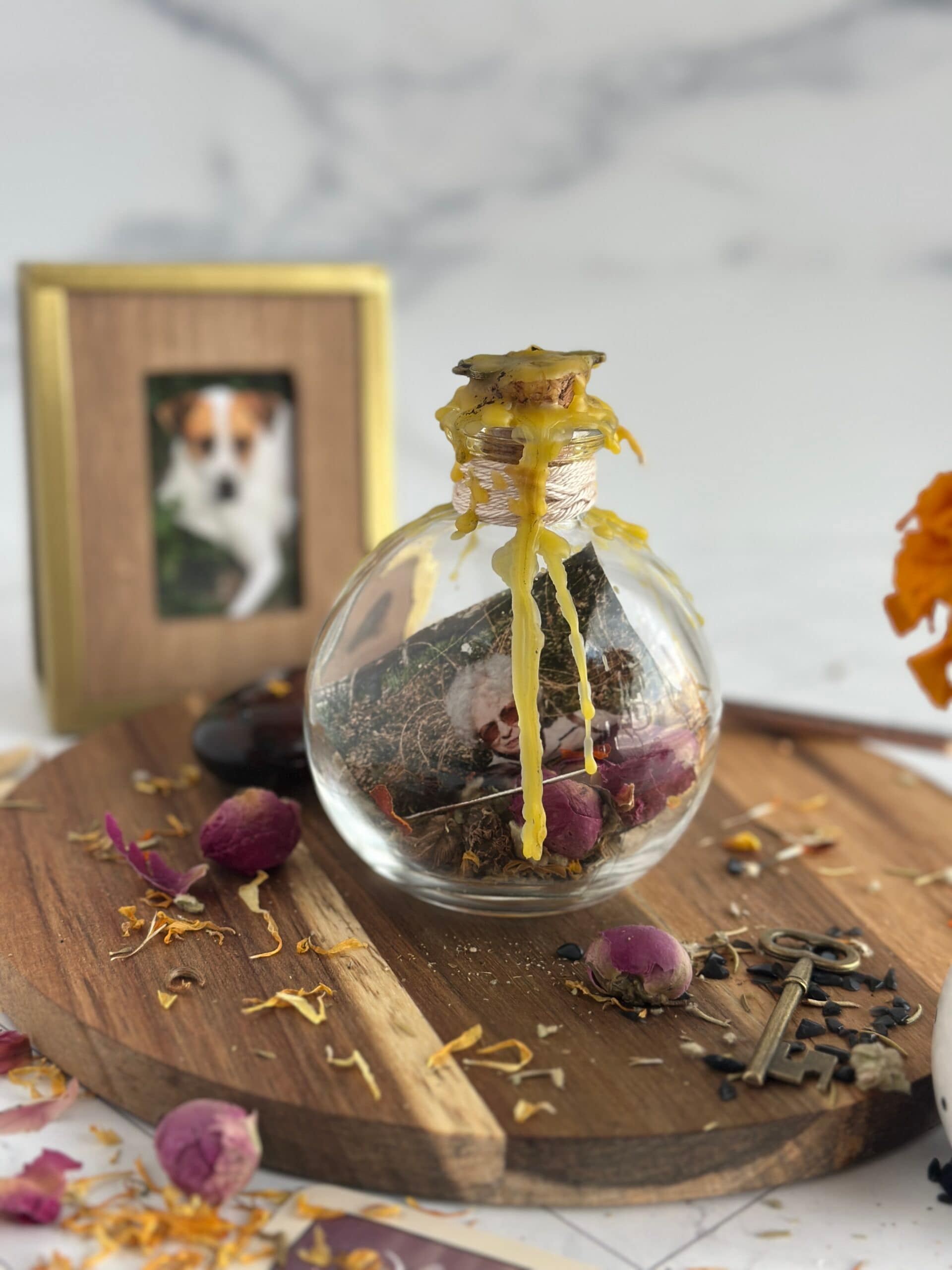 jar filled with ancestral herbs and memories, with wax on top, on altar