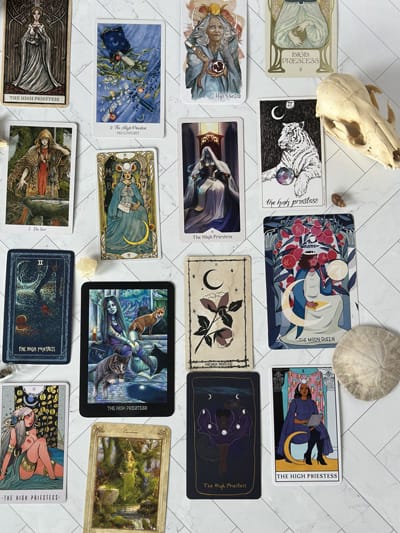 a varitey of high priestess cards from several tarot decks